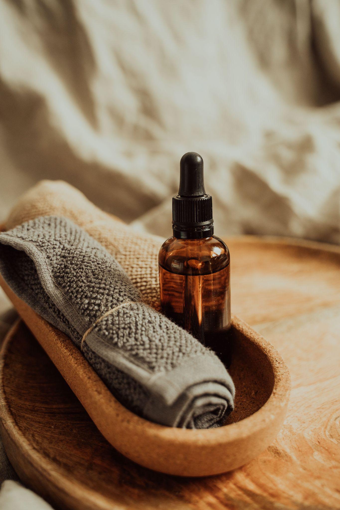 Oil and folded towels on a massage table