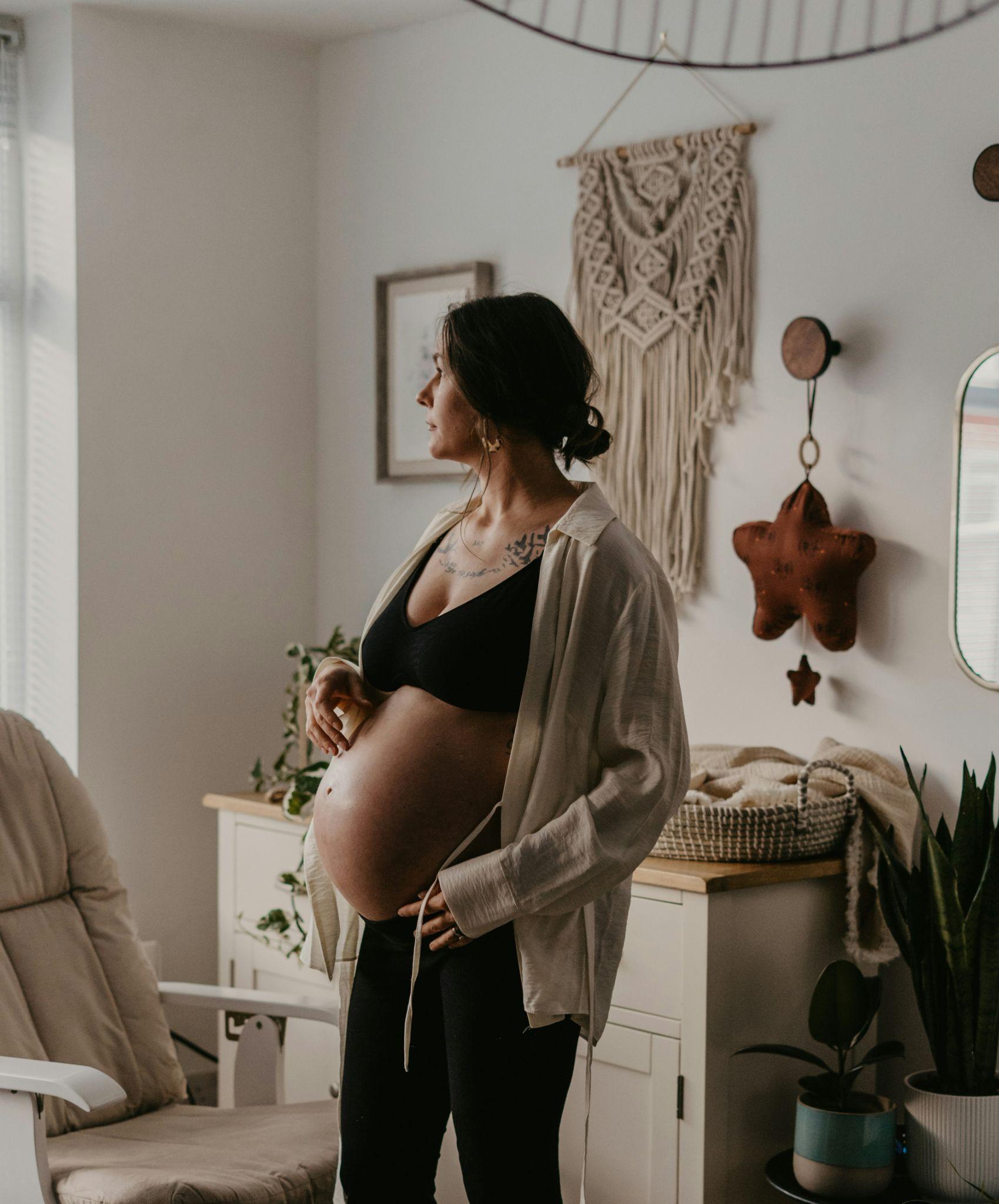 An expectant mother relaxes at home, illustrating the comfort of maternity massage in Clovis.