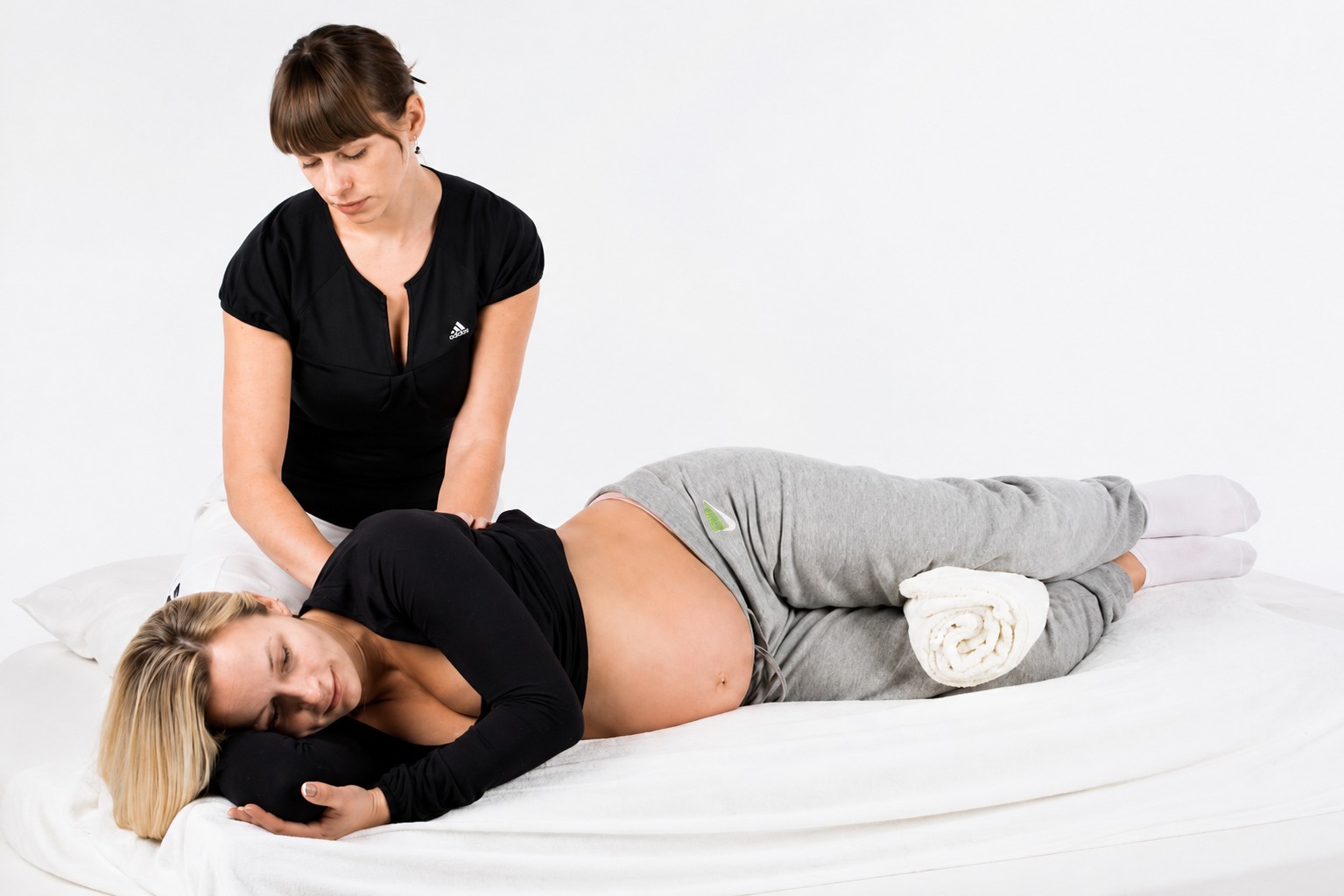 Pregnant woman receiving prenatal massage therapy in Central Valley.