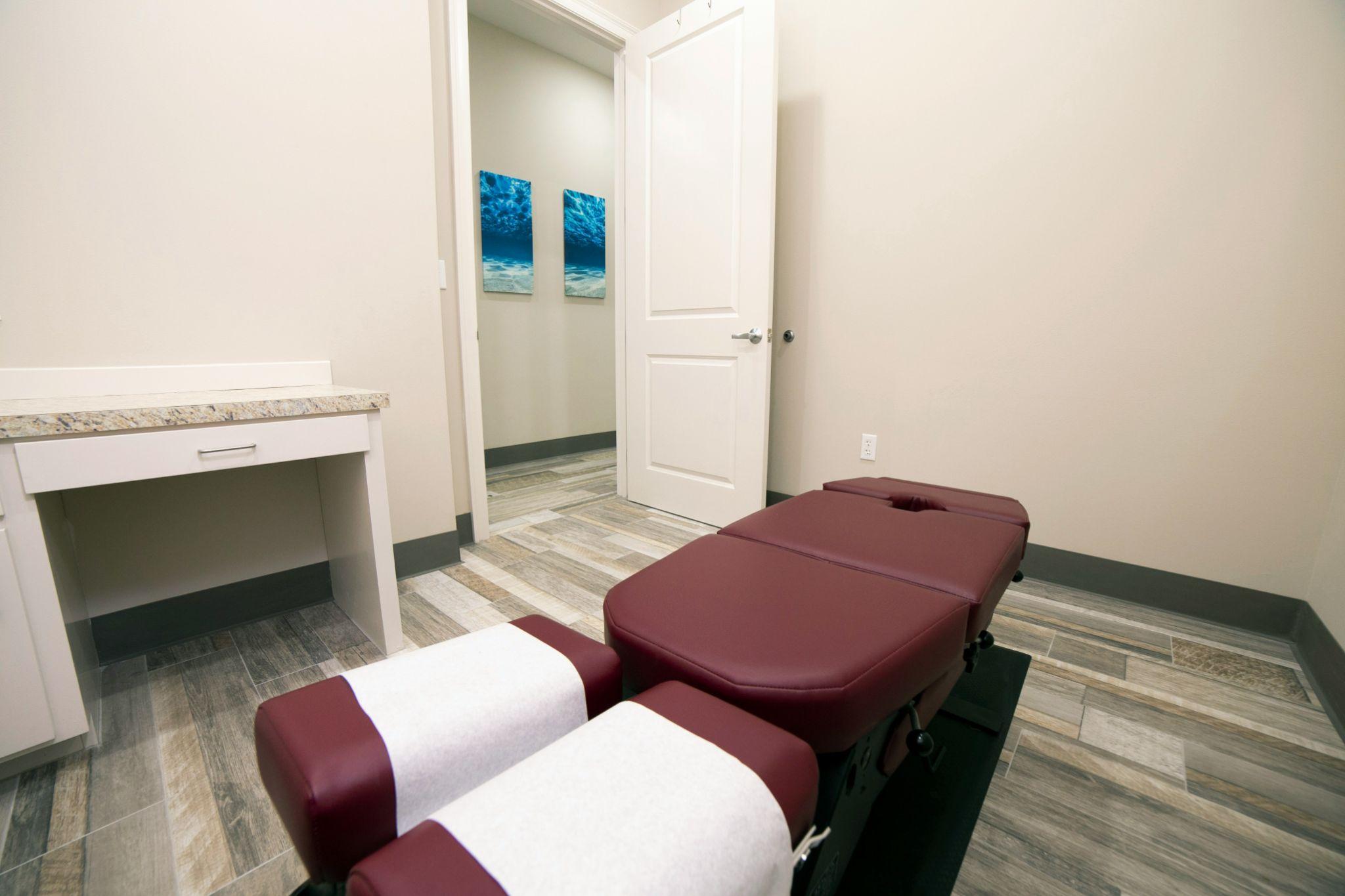 A relaxing massage room featuring a padded table for chair massage therapy in California.